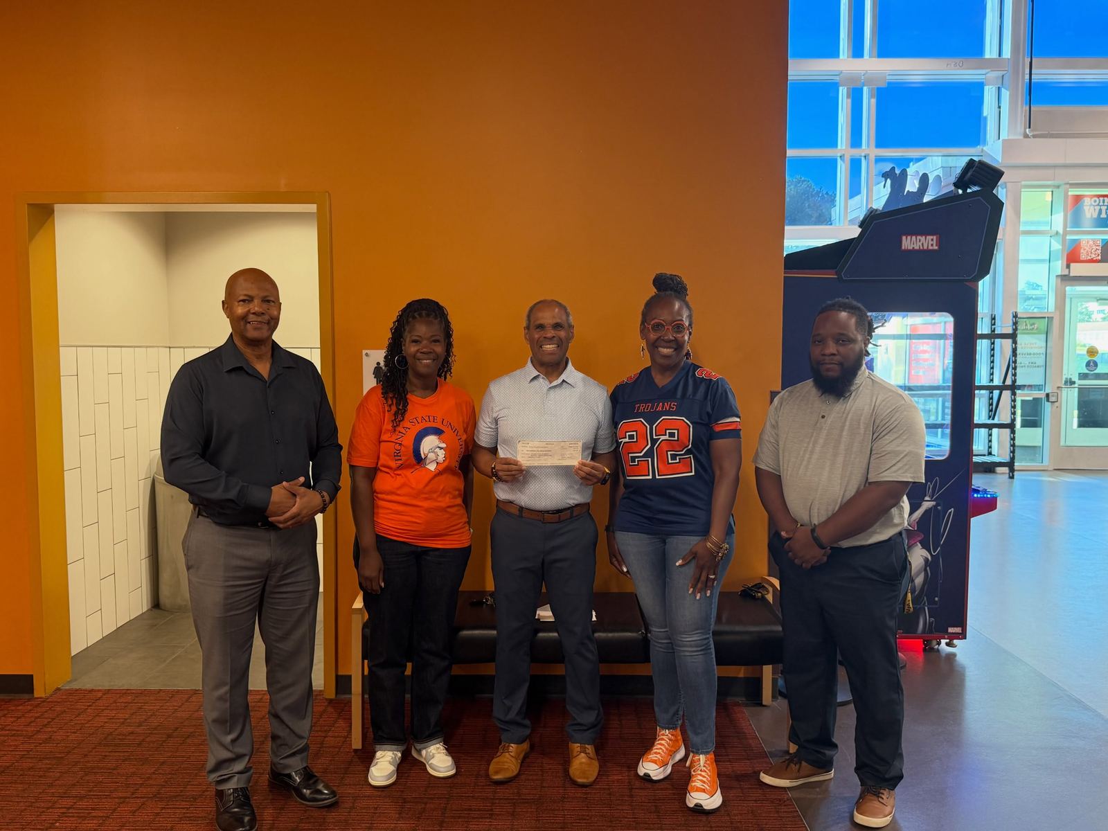 Chapter brothers present a check to members of the VSU Football Parents Association